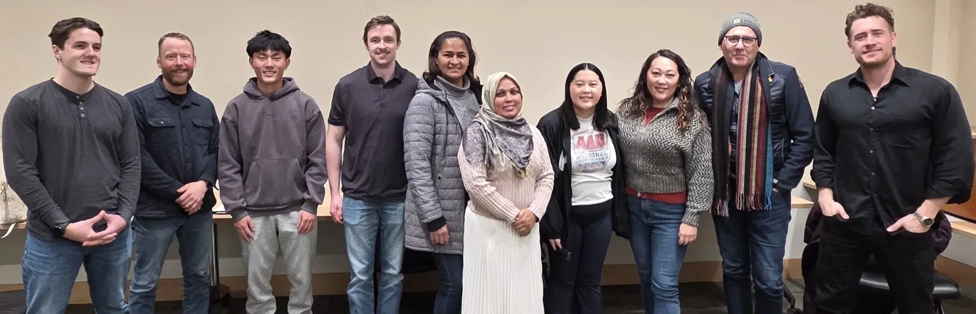 A recent workshop cohort standing with Joseph at the front of the room